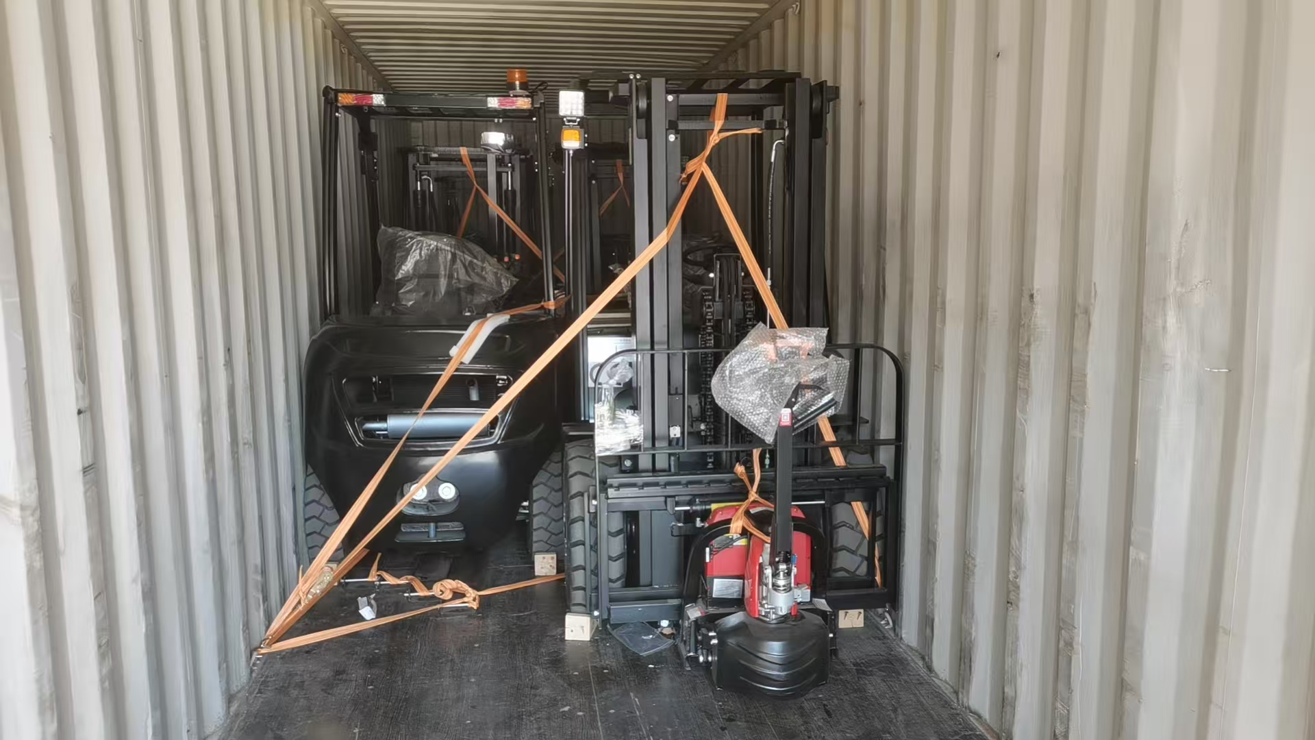 Forklifts secured inside a shipping container