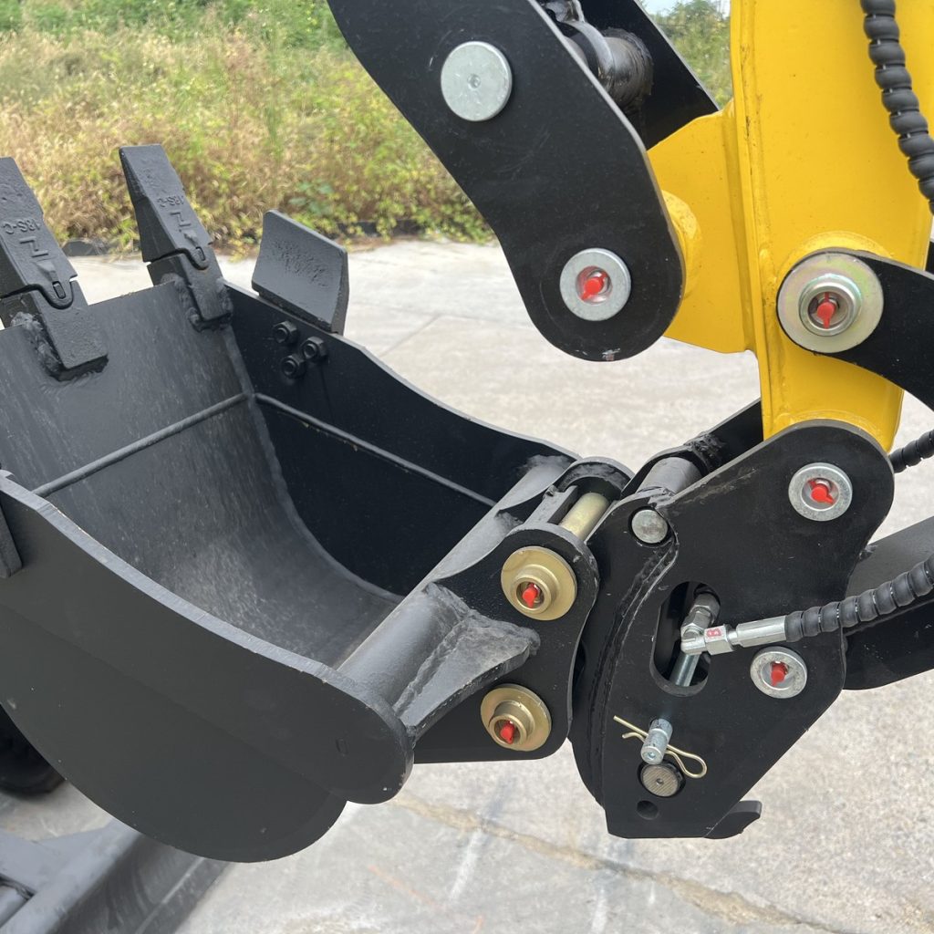 Mini excavator bucket mounting assembly with pins, linkage and a hydraulic hose
