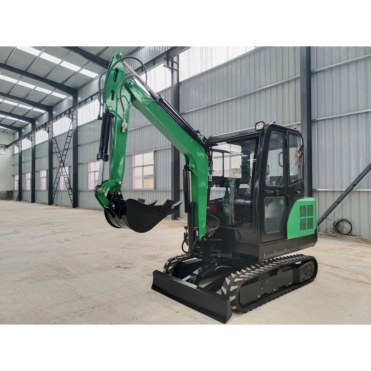 HL30 reference excavator with cab and digging bucket photographed inside the factory